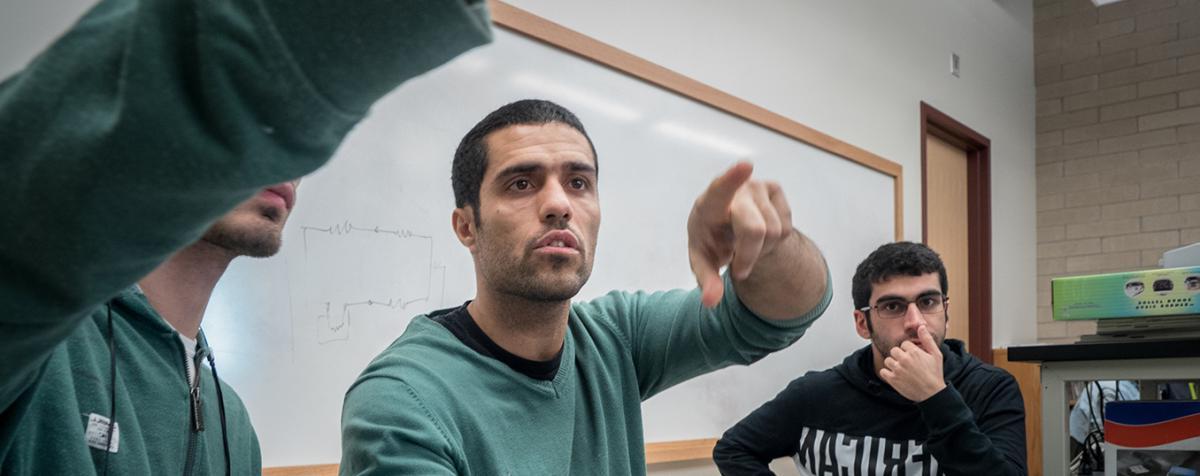 graduate students looking at computer